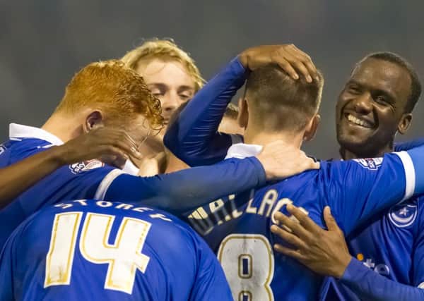 Pompey celebrate as they score their third goal in the 3-0 win against Morecambe