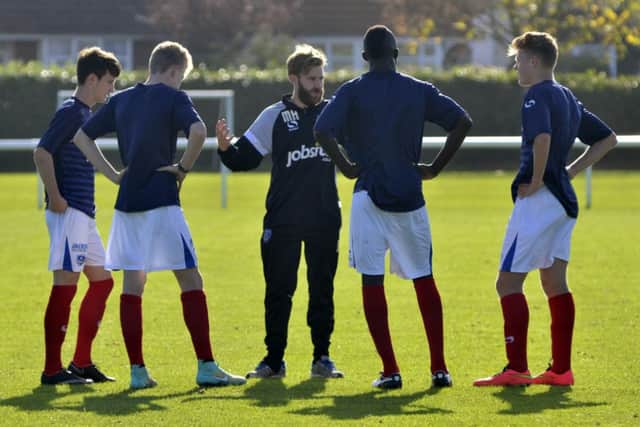 Pompey Academy coach Mikey Harris, centre, briefs his players. Picture: Neil Marshall