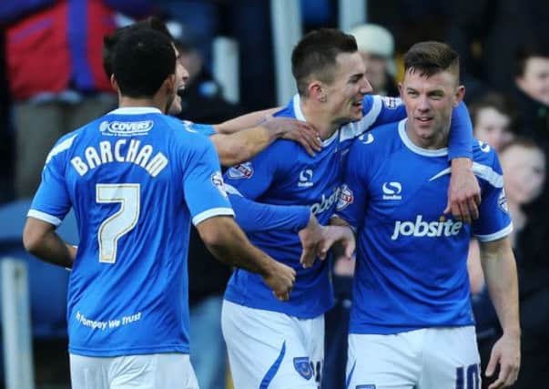 Tom Craddock, right, is congratuled by his Pompey team-mates after scoring against Scunthorpe in November 2013