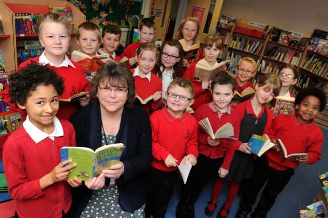 Mengham Junior School's headteacher Wendy Bolton, with a few of the school's pupils pictured in the library. The school has been graded good across the board by Ofsted.Picture: Allan Hutchings (150217-719) PPP-150902-103035001