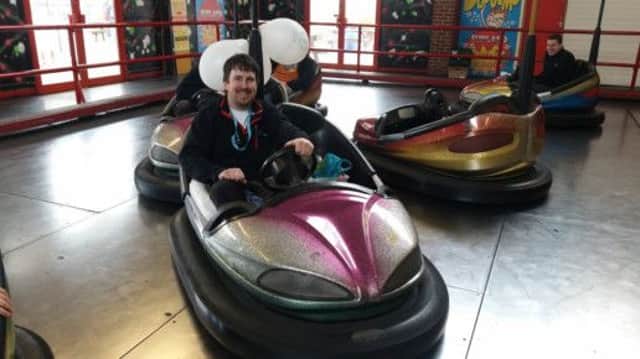 BUMPER OCCASION Tired but jubilant, Marcus Gaines smashes the world record for the longest time a bumper car has been driven. Picture: Joe Roberts
