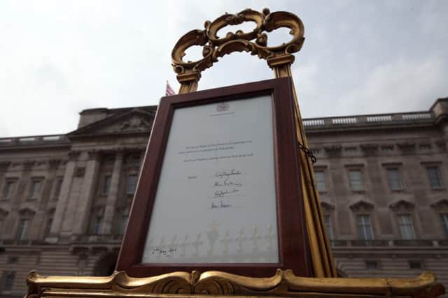 An easel is placed in the Forecourt of Buckingham Palace in London to announce the birth of a baby girl.Picture: Steve Parsons/PA Wire