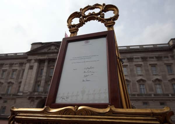 An easel is placed in the Forecourt of Buckingham Palace in London to announce the birth of a baby girl.Picture: Steve Parsons/PA Wire