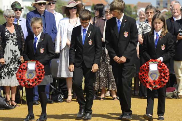 Pupils from Hayling College lay wreaths on The COPP Memorial
Picture: Malcolm Wells (150701-4784)
