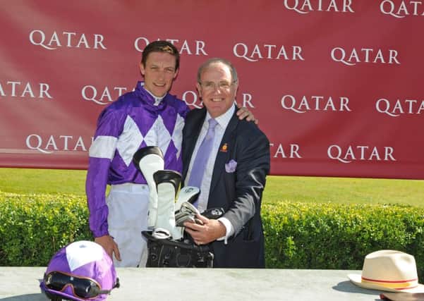 Richard Hughes is presented with a set of golf clubs by Goodwood's Seamus Buckley / Picture by Malcolm Wells