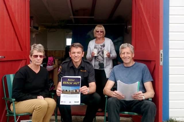 From left, beach hut owner Annie Richards with firefighter Glen Willie, Pauline Byrne and Nick Tupper