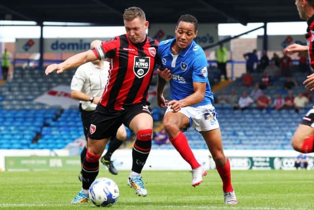 Kyle Bennett battles it out for Pompey against Morecambe at Fratton Park   Picture: Joe Pepler