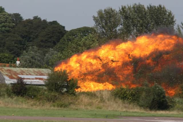 Flames at the scene of the crash at the Shoreham Airshow today DM156565a.jpg Photo by Derek Martin SUS-150822-170409008