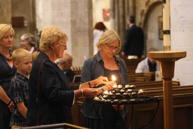 DM155899a Lighting candles after the service at St Mary de Haura