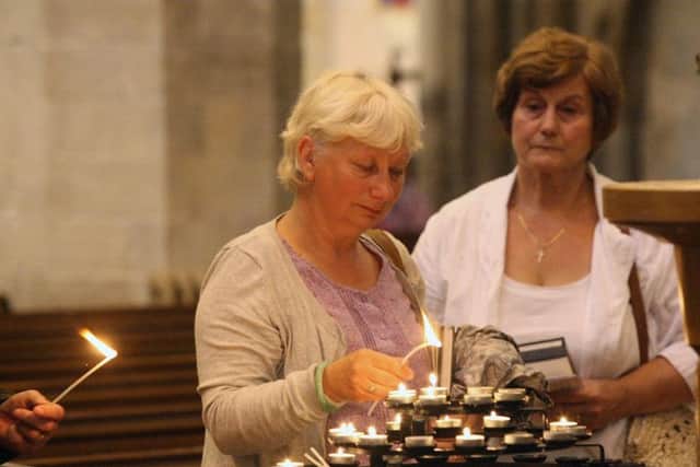 DM155928a.jpg Shoreham Airshow 2015. Lighting candles during service at St Mary's church, Shoreham. Photo by Derek Martin SUS-150823-120128008