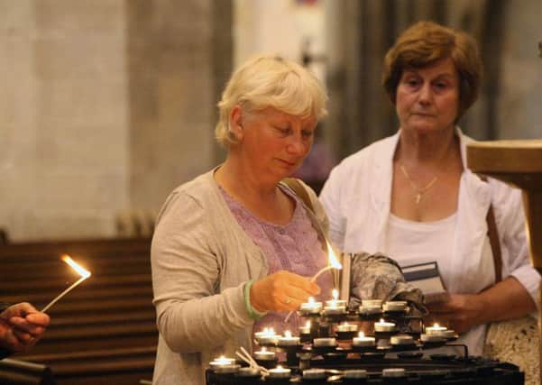 DM155928a.jpg Shoreham Airshow 2015. Lighting candles during service at St Mary's church, Shoreham. Photo by Derek Martin SUS-150823-120128008