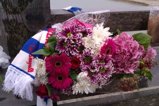 Flowers wrapped in a Brighton and Hove Albion scarf