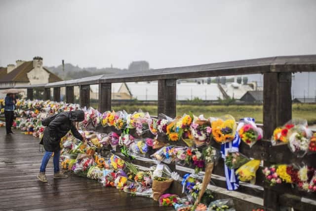The number of floral tributes being left on the Old Toll Bridge is also growing