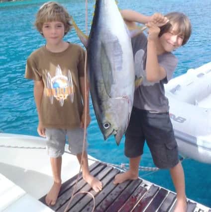 Sam and Fin with a yellow fin tuna they caught