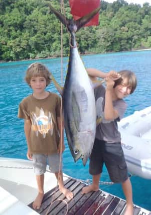 Sam and Fin with a yellow fin tuna they caught