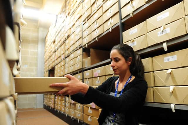 Senior Archivist, Jennifer Mason, archiving the items.ks1500488-6 SUS-150928-164059008