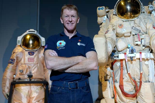 British astronaut Tim Peake poses beside spacesuits as he talks to UK media at the Science Museum, London, before being launched into space PRESS ASSOCIATION Photo. Picture date: Friday November 6, 2015. Peake, 43, will embark for a six-month stay on the International Space Station on December 15. See PA Story: SCIENCE Peake. Photo credit should read: Anthony Devlin/PA Wire SUS-150611-133843001