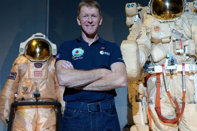 British astronaut Tim Peake poses beside spacesuits as he talks to UK media at the Science Museum, London, before being launched into space Picture: Anthony Devlin/PA Wire