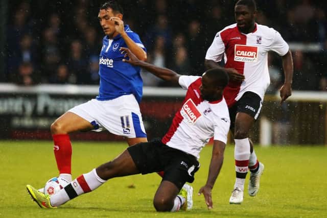 Godfrey Poku, right, in action against Pompey for Woking in pre-season. Picture: Joe Pepler