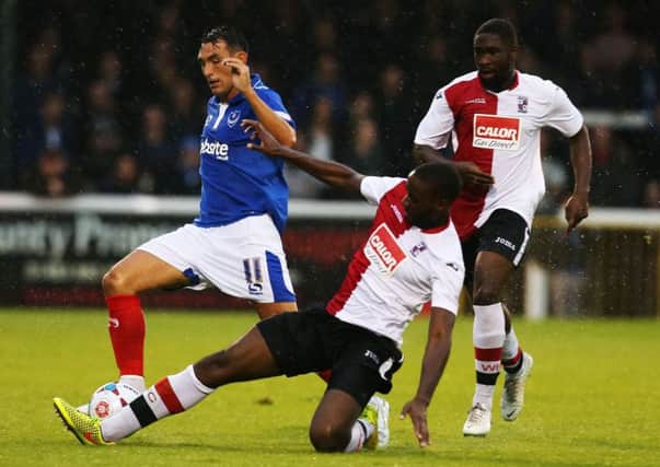 Godfrey Poku, right, in action against Pompey for Woking in pre-season. Picture: Joe Pepler