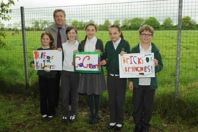 Wicor Primary School's headteacher Mark Wildman during last year's protests against building on the field off Cranleigh Road, Portchester. He is with pupils., from left, Izzy Hookings, Amelia Jenkins, Lily Salter, Maddison Jayes and Dylan Ayling
Picture: Paul Jacobs (150521-1)