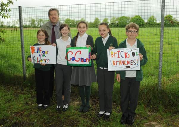 Wicor Primary School's headteacher Mark Wildman during last year's protests against building on the field off Cranleigh Road, Portchester. He is with pupils., from left, Izzy Hookings, Amelia Jenkins, Lily Salter, Maddison Jayes and Dylan Ayling
Picture: Paul Jacobs (150521-1)