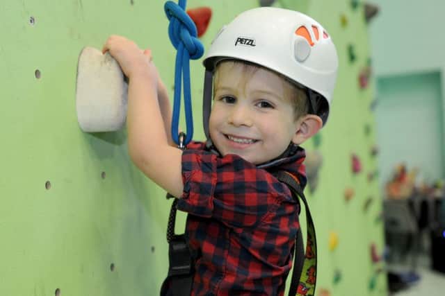 Charlie Jackson, 4, tries the climbing wall