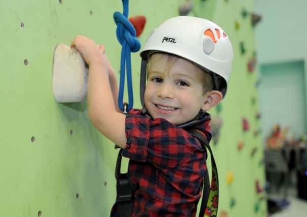 Charlie Jackson, 4, tries the climbing wall