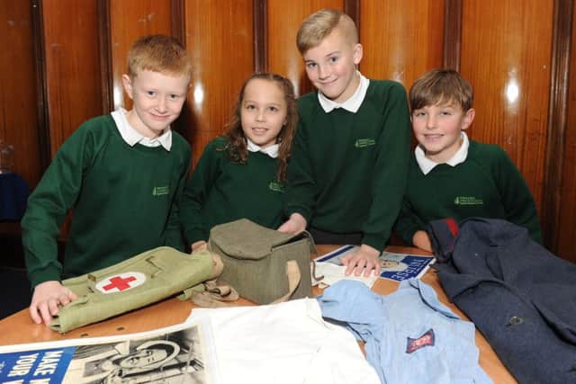 Children from Portsmouth schools learnt about the Blitz for the 75th anniversary of the bombing of the city on Monday the Portsmouth Guildhall. Pictured is: (l-r) Liam Maddox (9), Maya Flint (10), Matthew Pilbeam (10) and Jack Chamberlain (9) from Fernhurst Junior School looking at artefacts. Picture: Sarah Standing (160090-7846)