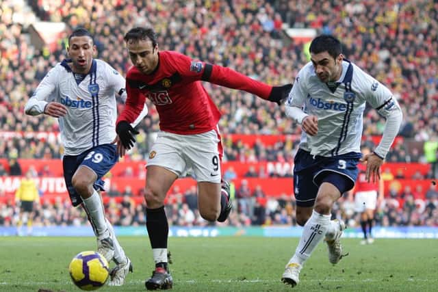 Portsmouth's Nadir Belhadj (left) and Ricardo Rocha (right) battle for the ball with Manchester United's Dimitar Berbatov