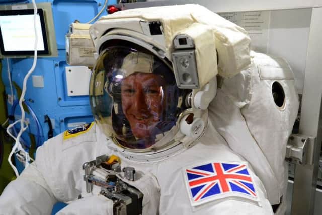 Tim Peake tries on his suit before his historic spacewalk on Friday PHOTO: Twitter