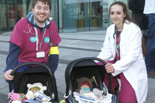 Junior doctors Callum Ettles and Becky Beamish, with babies Edith (left) and Agnes Davies from Southsea, on the picket line at QA Hospital . Picture: Jason Kay