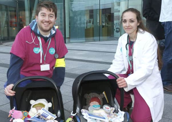 Junior doctors Callum Ettles  and Becky Beamish, with babies Edith (left) and Agnes Davies  from Southsea,  on the picket line at QA Hospital . Picture:  Jason Kay