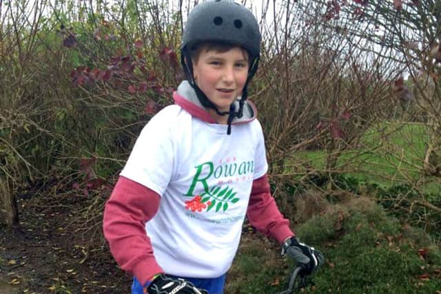 Rhys Clifford braved the weather to complete a sponsored bike ride for Rowans Hospice