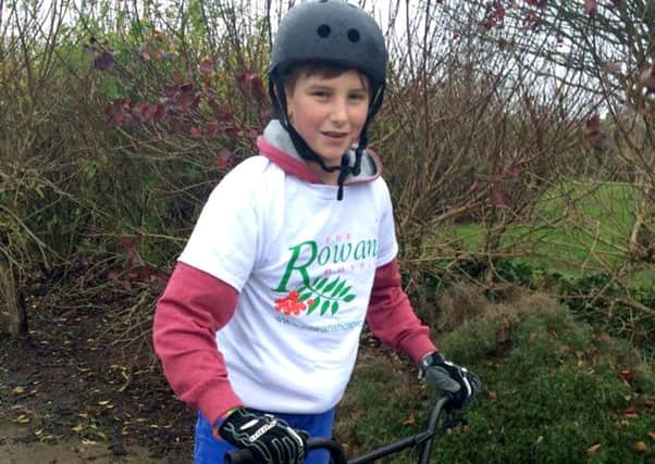 Rhys Clifford braved the weather to complete a sponsored bike ride for Rowans Hospice