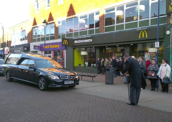 The funeral cortege of Chris Woodford stops outside McDonald's in Gosport high street, where she worked for many years