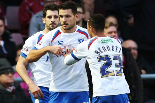 Gareth Evans, centre, takes the acclaim of his team-mates after scoring at Northampton  one of three goals in December