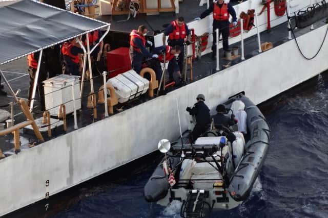 Bales of seized cocaine being transferred to the US Coast Guard as the crew of Royal Fleet Auxiliary Naval Support Ship, RFA Wave Knight, take part in an international counter-narcotics operation in the Caribbean, seizing an illicit cargo of cocaine with a UK wholesale value of over £60m