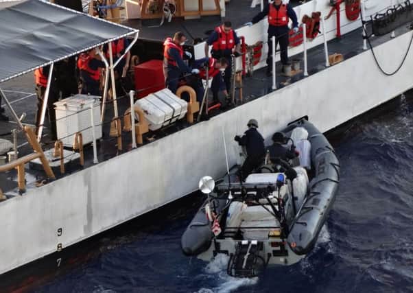 Bales of seized cocaine being transferred to the US Coast Guard as the crew of Royal Fleet Auxiliary Naval Support Ship, RFA Wave Knight, take part in an international counter-narcotics operation in the Caribbean, seizing an illicit cargo of cocaine with a UK wholesale value of over Â£60m