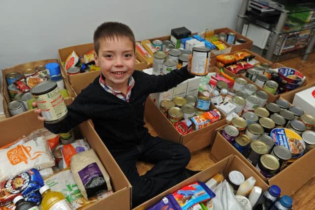 Eight-year-old Ronnie Hazlie from Gosport who has collected hundreds of tins of food for a food bank (160033-2)