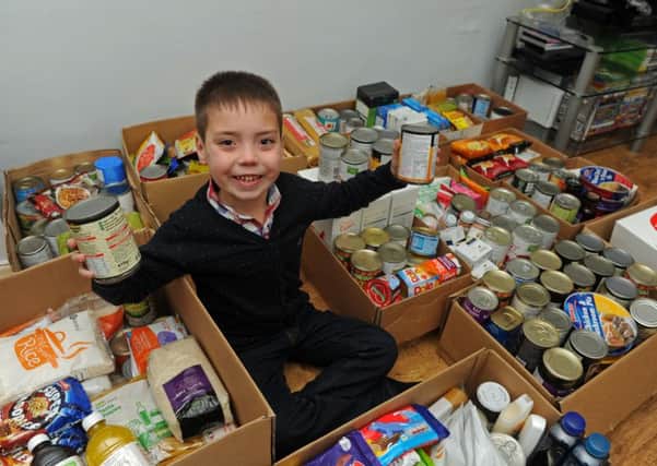 Eight-year-old Ronnie Hazlie from Gosport who has collected hundreds of tins of food for a food bank (160033-2)