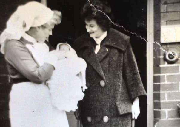 Patricia Bryant taking home her son Mark from Eddystone Maternity Home in May 1963. Mark is held by Matron Scott.