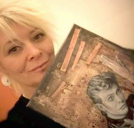 Helena Heath with her painting for the auction