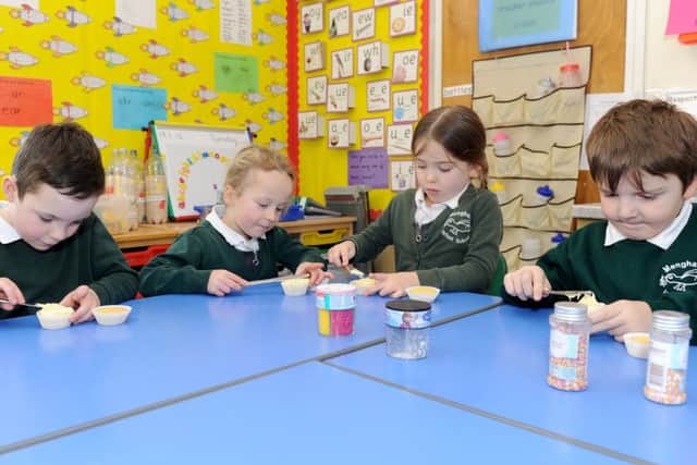 (L-r) Persian Woods (5), Georgina Chevis (6), Sophie Brown (5) and Toby Pyatt (5) decorating their cupcakes Picture: Sarah Standing (160106-8782)