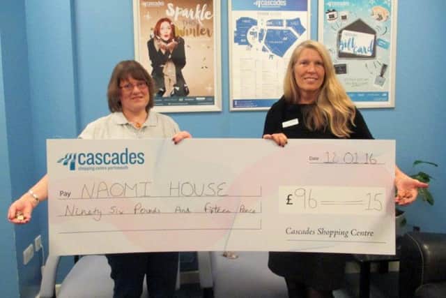 Area fundraiser for Naomi House Sarah Hudson, left, and Cascades Centre manager Rhoda Joseph with the cheque for money from the wishing well