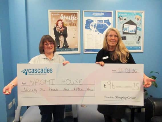 Area fundraiser for Naomi House Sarah Hudson, left, and Cascades Centre manager Rhoda Joseph with the cheque for money from the wishing well