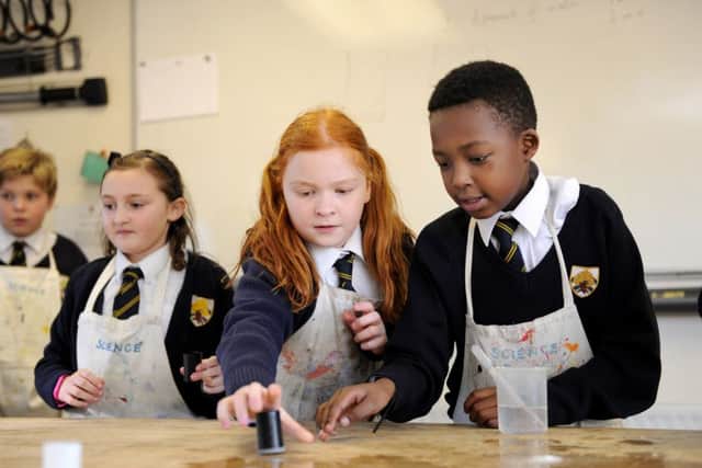 At the front, Isla Ransom, nine, and Terry Gapa, 10, during a science lesson, in which old 35mm film cases were filled with water and Alka-Seltzer until they popped and jumped in the air
Picture: Paul Jacobs (160009-3)