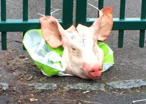 A pig's head left tied to the Madani school gate in Portsmouth, with an  obscene message