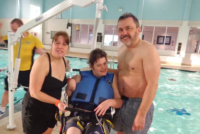 HAPPY Holly Styles in the pool hoist with her parents Gail and Mike