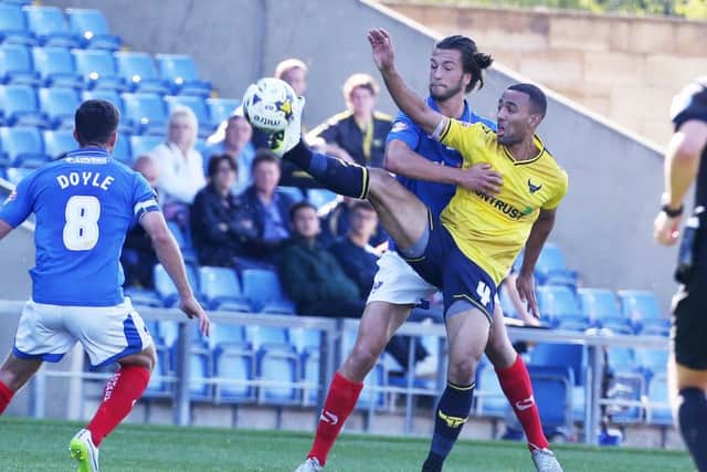 Christian Burgess battles with Oxford's Kemar Roofe earlier in the season Picture: Joe Pepler